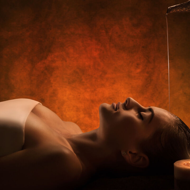 The girl has Shirodhara treatment - indian oil massage.