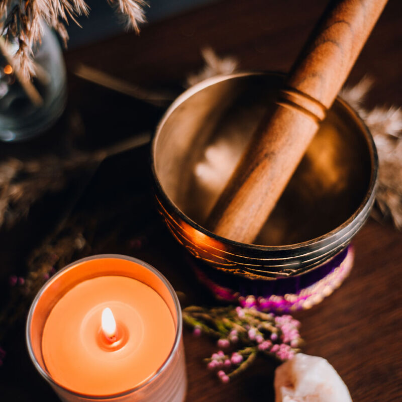 spa still life with candle, crystal and singing bowl for meditat